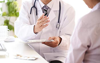 Doctor speaking to patient with a clipboard