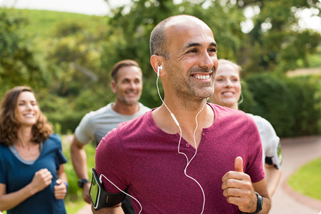 Man happily running with a group of friends