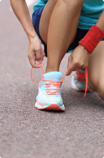 Tying blue shoes in the street