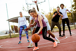 Young adults playing a friendly game of basketball