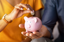 Couple saving money in piggybank