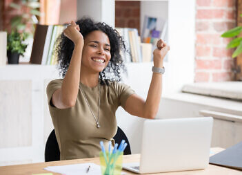 Excited woman sit at desk feel euphoric win online rewards, happy woman overjoyed get rewards at laptop being promoted at work, girl amazed read good news at computer