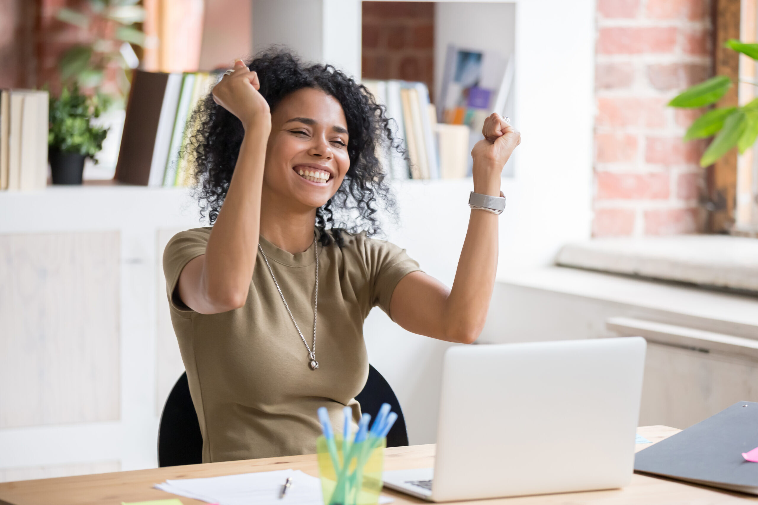 Excited woman sit at desk feel euphoric win online rewards, happy woman overjoyed get rewards at laptop being promoted at work, girl amazed read good news at computer