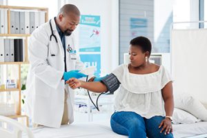 Middle aged women slightly overweight visiting her primary care provider getting a blood pressure check