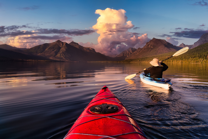 Adventurous Man Kayaking in Lake McDonald