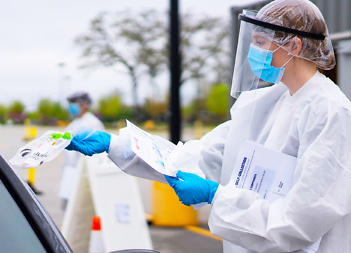 Screener hanging a patient a test kit